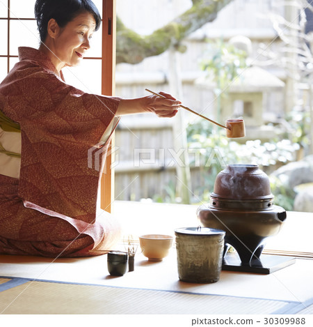 A woman enjoying a tea ceremony 30309988