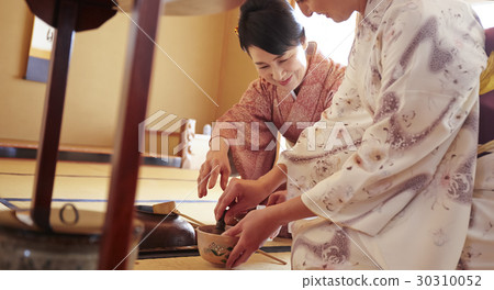 A woman learning a tea ceremony A woman learning a tea ceremony 30310052