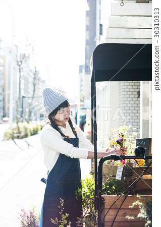 Female clerk in a flower shop 30310313