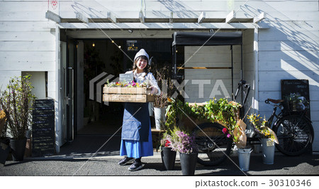 Female clerk in a flower shop 30310346