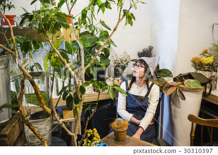 Female staff in a flower shop 30310397