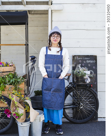 Female clerk in a flower shop Female clerk in a flower shop 30310400