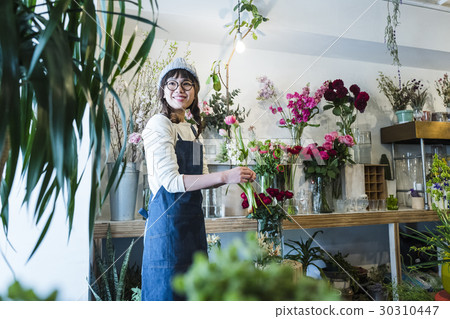 Female staff in a flower shop 30310447