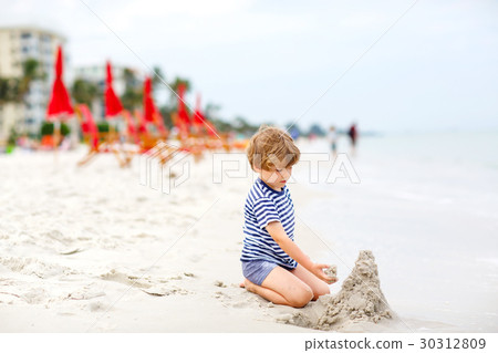 Little kid boy having fun with building sand 30312809