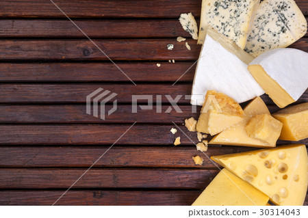 Various cheeses on wooden table with empty space. 30314043