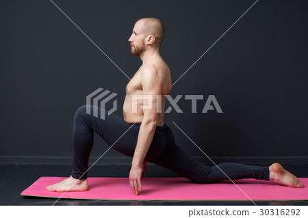 Young man is doing front lunge Young man is doing front lunge 30316292