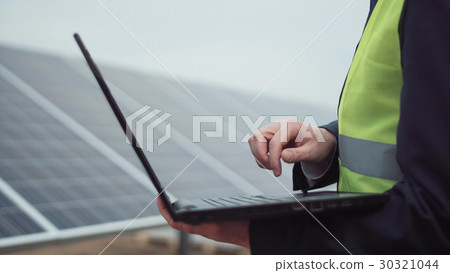 The worker with laptop on site 30321044