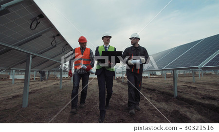 Engineers discuss building of a solar farm Engineers discuss building of a solar farm 30321516