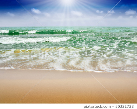 Beach sand and blue sea with sunbeam in blue sky Beach sand and blue sea with sunbeam in blue sky 30321728