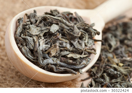 Green tea  in wooden spoon and tea leaves 30322424