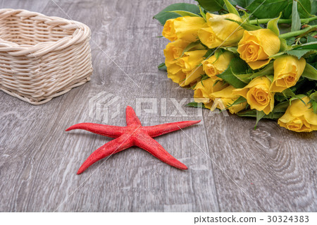 Red starfish and roses on a wooden background Red starfish and roses on a wooden background 30324383
