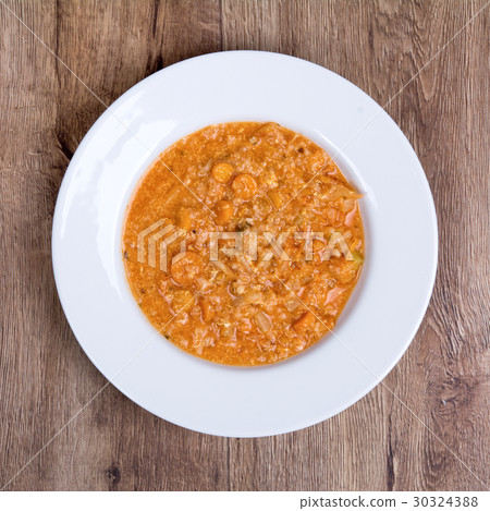 Vegetable soup on a wooden table Vegetable soup on a wooden table 30324388