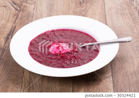 Vegetable soup on a wooden table 30324421