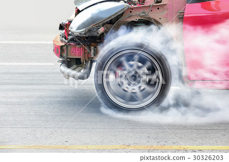race car burns rubber off its tires in preparation for the race 30326203