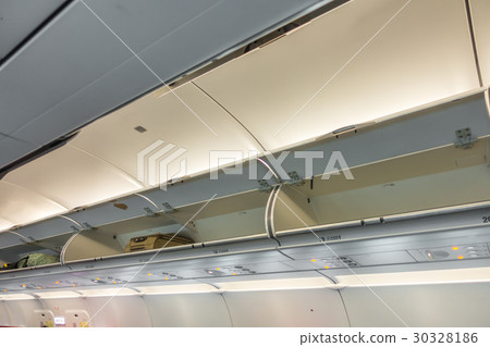 Overhead compartment in commercial airplane .( Filtered image processed vintage effect. ) 30328186