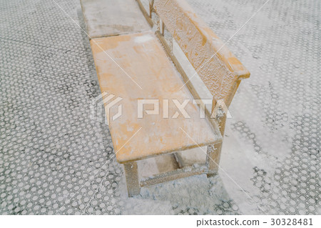 Empty chairs covered with snow in winter . 30328481