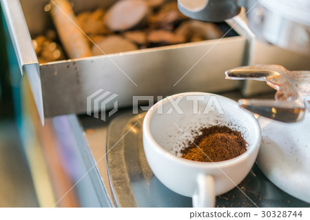 Used coffee grounds from espresso machine . Used coffee grounds from espresso machine . 30328744