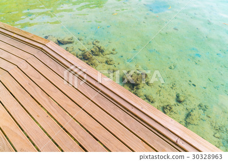 Top view of wooden deck in tropical Maldives island and beauty of the sea with the coral reefs . Top view of wooden deck in tropical Maldives island and beauty of the sea with the coral reefs . 30328963