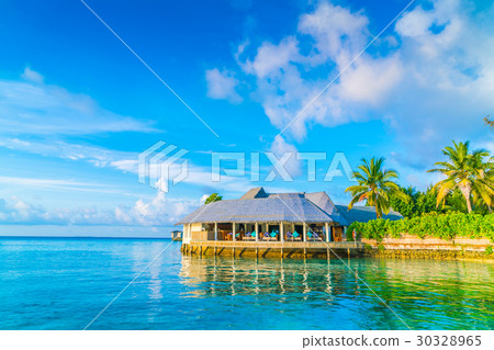 Beautiful water villas in tropical Maldives island at the sunrise time . Beautiful water villas in tropical Maldives island at the sunrise time . 30328965