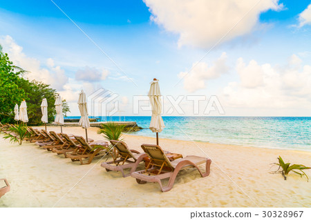 Beach chairs with umbrella at Maldives island, white sandy beach and sea . Beach chairs with umbrella at Maldives island, white sandy beach and sea . 30328967