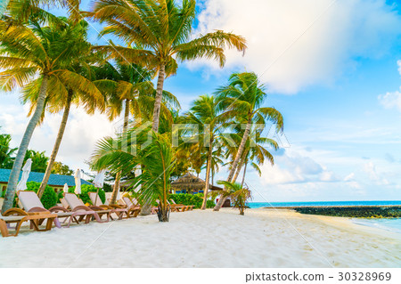 Beach chairs with umbrella at Maldives island, white sandy beach and sea . Beach chairs with umbrella at Maldives island, white sandy beach and sea . 30328969