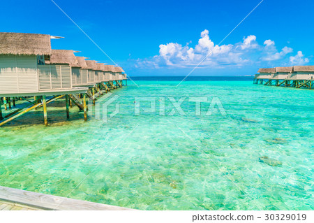 Beautiful water villas in tropical Maldives island . 30329019