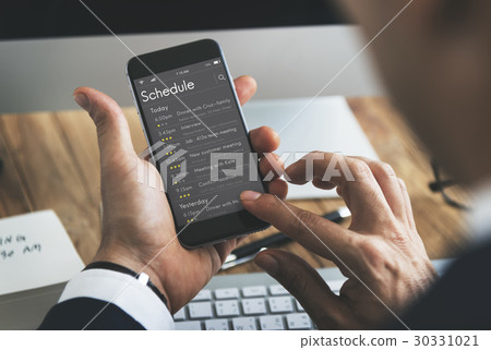 Man checking appointment on personal organizer schedule 30331021