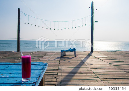 Bright drinks on the table with the sea 30335464
