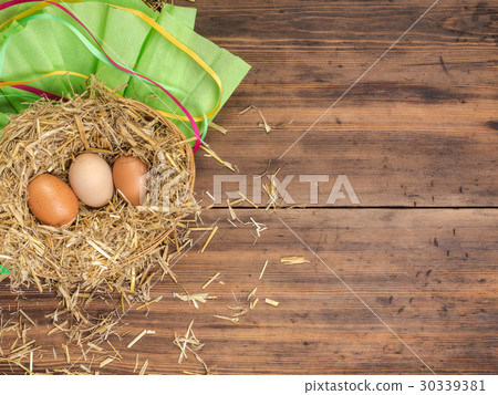 Brown eggs in hay nest. Rural eco background with Brown eggs in hay nest. Rural eco background with 30339381