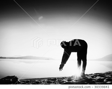Deep breathing runner bended with hands on down Deep breathing runner bended with hands on down 30339841