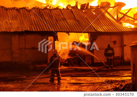Firefighters extinguish a fire 30343170