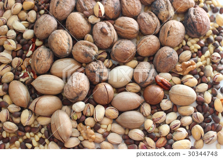 Spilled nuts of different kinds Spilled nuts of different kinds 30344748