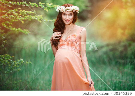 Young beautiful pregnant girl with long brown hair Young beautiful pregnant girl with long brown hair 30345359