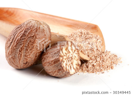 nutmeg and half with powder in a scoop isolated on nutmeg and half with powder in a scoop isolated on 30349445