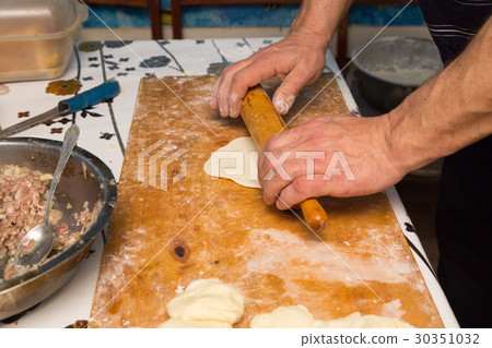 man prepares dumplings at home 30351032