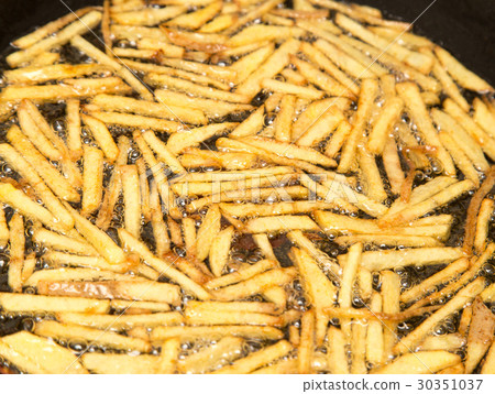 cooking potato fries in oil 30351037