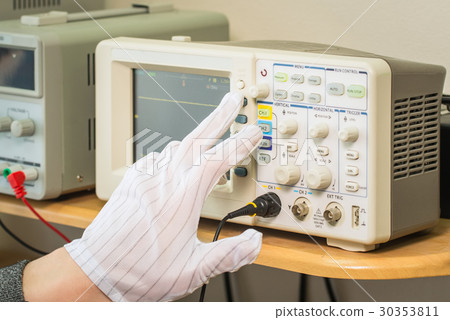 Modern oscilloscope, man's hand adjusting wave Modern oscilloscope, man's hand adjusting wave 30353811