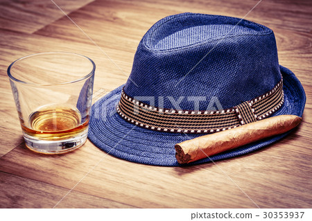 blue hat with cigar and expensive drink of whisky 30353937