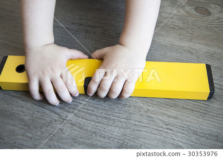 spirit level in young boy hand - child waterlevel 30353976