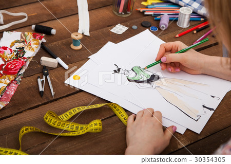 Fashion designer drawing new models of clothes 30354305