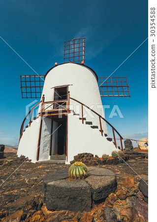 Windmill in cactus garden in Guatiza village Windmill in cactus garden in Guatiza village 30354588