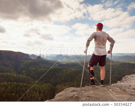 Hiker, medicine crutch and leg fixed in immobilize 30354827