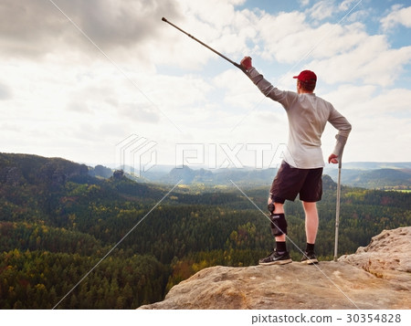 Hiker huts knee. Man with leg in immobilizer Hiker huts knee. Man with leg in immobilizer 30354828