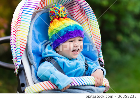 Baby boy in stroller in autumn park 30355235