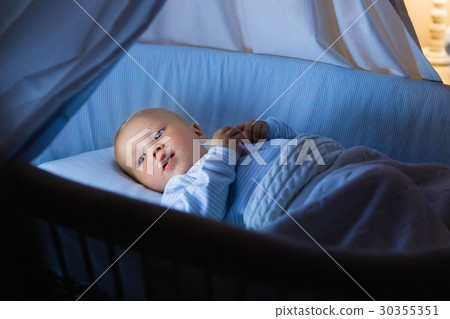 Baby boy drinking milk in bed 30355351