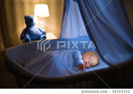 Baby boy drinking milk in bed Baby boy drinking milk in bed 30355352