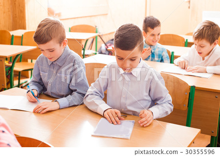 Boy white in the copybook 30355596