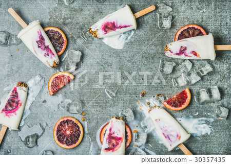 Orange, yogurt, granola popsicles on ice cubes Orange, yogurt, granola popsicles on ice cubes 30357435