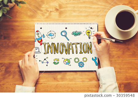 Innovation text with a person holding a pen Innovation text with a person holding a pen 30359548
