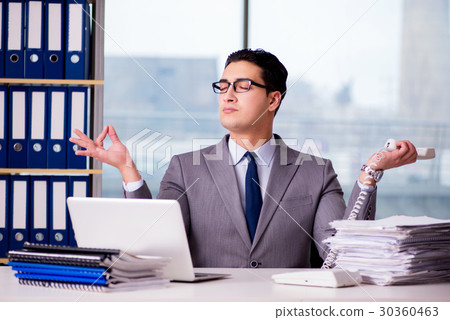 Businessman meditating in the office 30360463